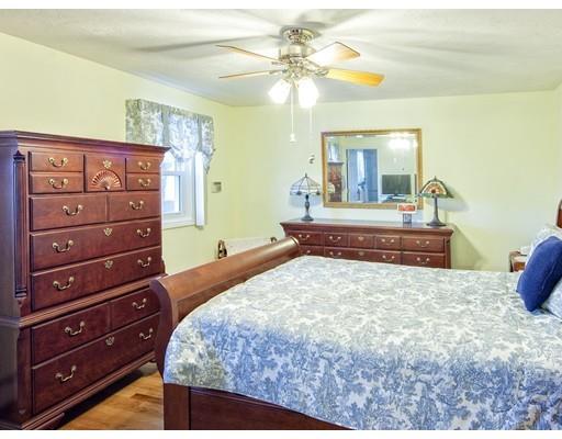 1 Long Boat Road Bourne, MA 02532 - Photo 14 of 29 a bedroom with a bed and a chandelier