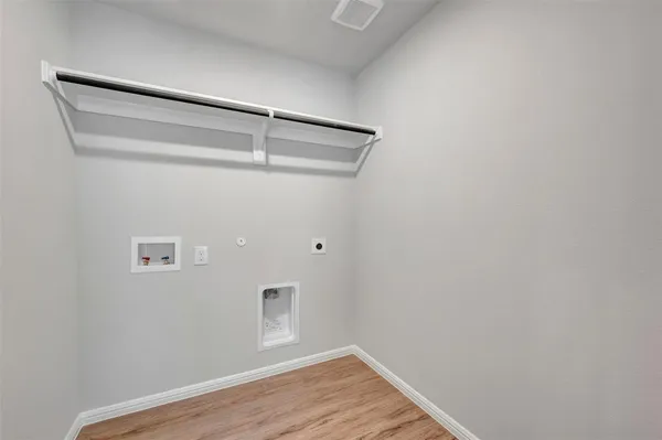 a view of an empty room with a kitchen