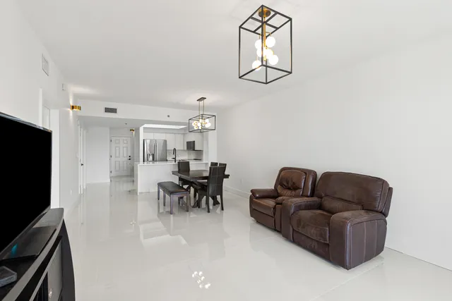 a living room with furniture a dining table and chairs