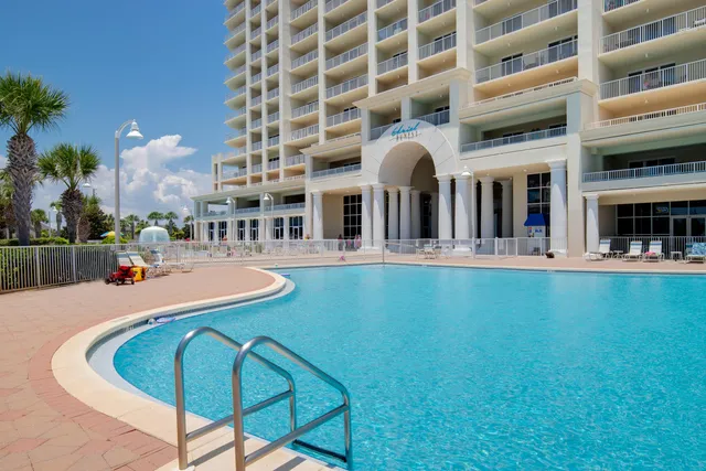 a swimming pool with outdoor seating and yard