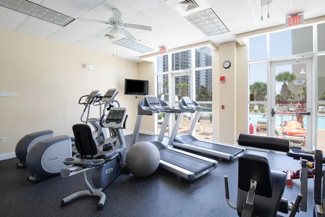 a room with gym equipment and windows