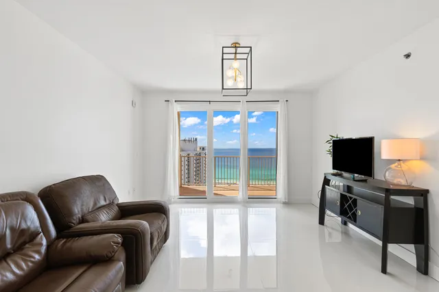 a view of a livingroom with workspace and a couch