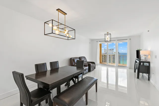 a view of a dining room with furniture and a window