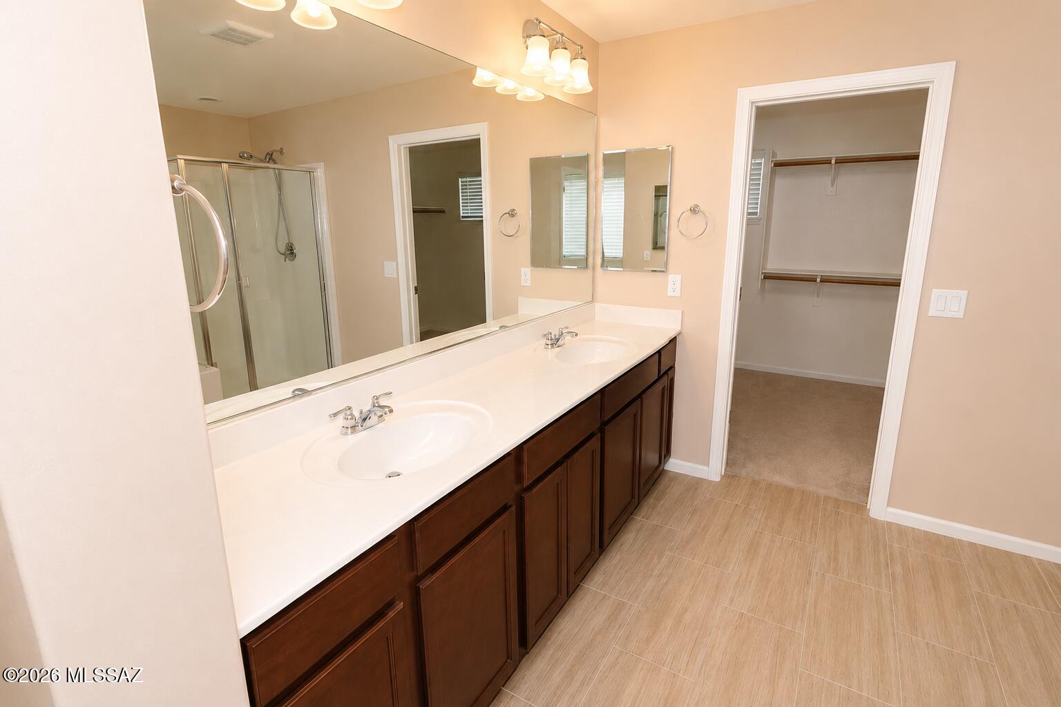 11484 East Desert Raptor Loop Tucson, AZ 85747 - Photo 6 of 28 a bathroom with a double vanity sink and mirror