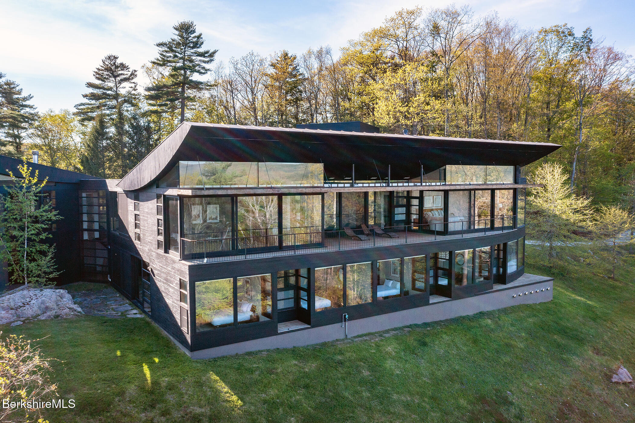 250 Long Pond Road Great Barrington, MA 01230 - Photo 3 of 56 a view of a house with backyard porch and wooden deck
