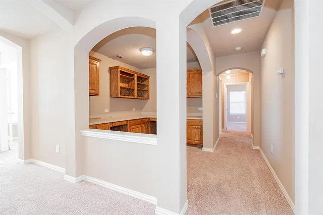 a view of a hallway view with wooden floor and staircase
