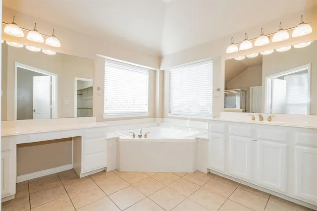 a bathroom with a sink mirror and a bathtub