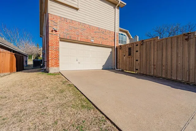 a view of a backyard with wooden fence