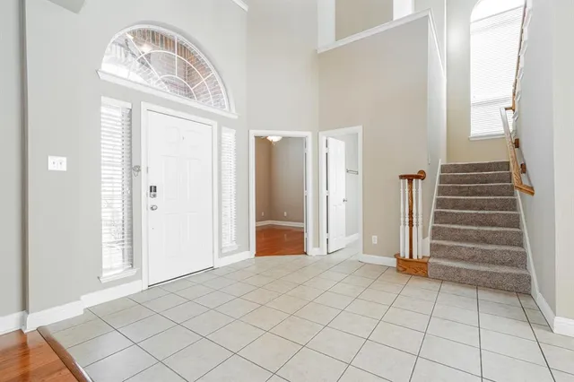 an empty room with fireplace and windows