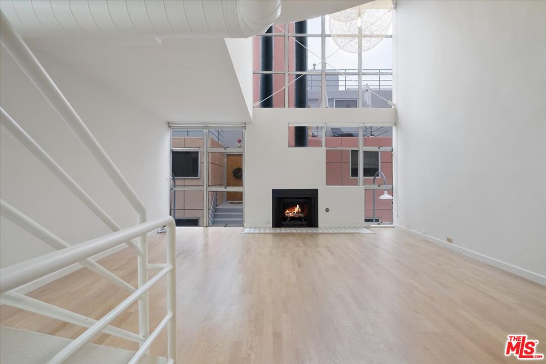 a view of a livingroom with wooden floor and fireplace