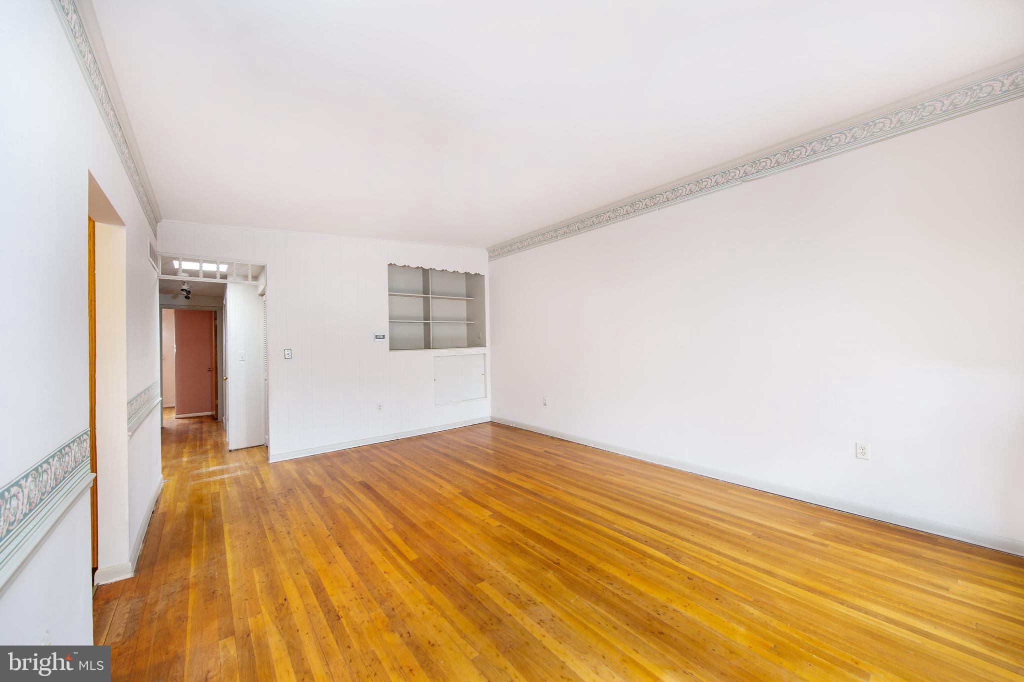 6831 Queens Ferry Road Baltimore, MD 21239 - Photo 8 of 30 Living Room with Hardwood Floors/Built-in Shelving