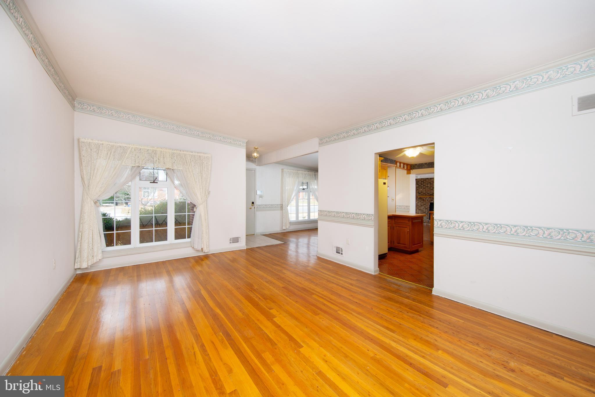 6831 Queens Ferry Road Baltimore, MD 21239 - Photo 9 of 30 Living Room with Vaulted Ceiling