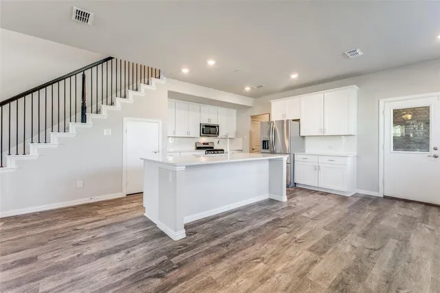 a kitchen with a sink stainless steel appliances and cabinets
