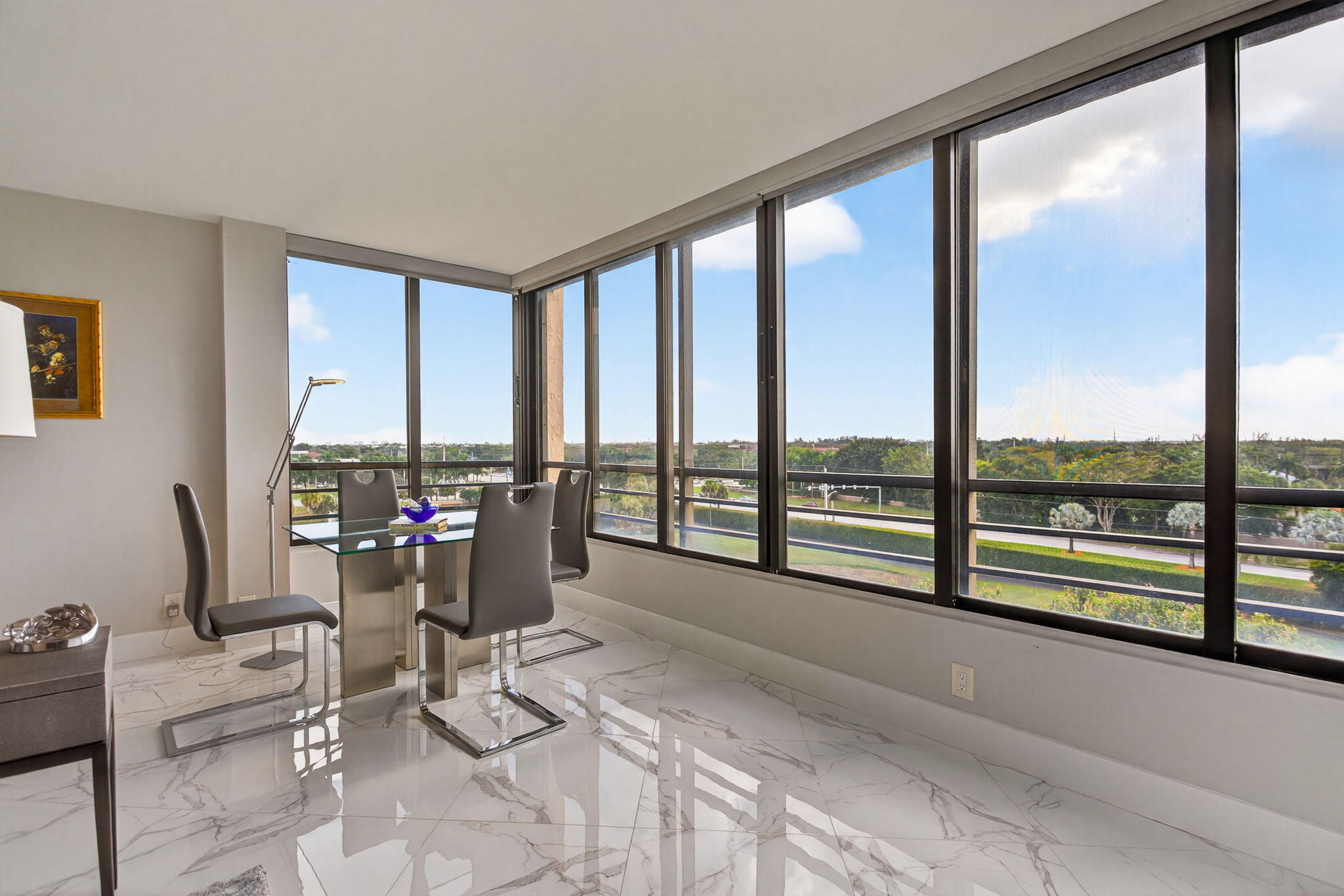 7186 Promenade Drive, Unit 701 Boca Raton, FL 33433 - Photo 5 of 39 a living room filled with furniture and floor to ceiling windows