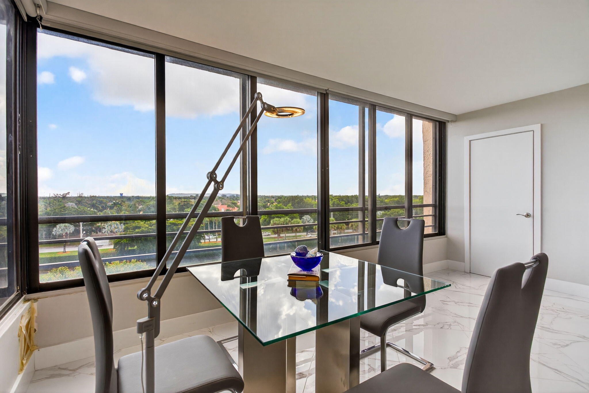 7186 Promenade Drive, Unit 701 Boca Raton, FL 33433 - Photo 10 of 39 a view of a living room with furniture and floor to ceiling windows
