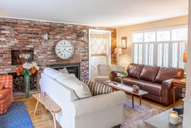 2 Fuller Road Centerville, MA 02632 - Photo 9 of 26 a living room with furniture a fireplace and a large window