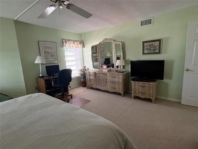 a bedroom with furniture and a flat screen tv