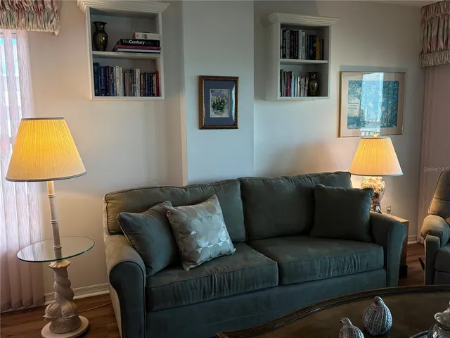 a living room with furniture and a lamp