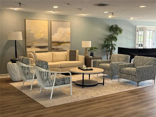 a view of a livingroom with furniture and a bookshelf