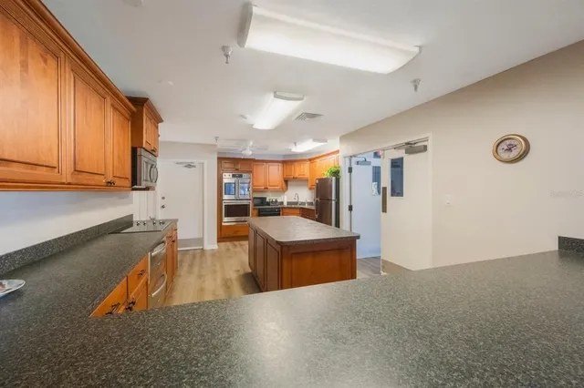 a kitchen with stainless steel appliances granite countertop a sink stove and cabinets