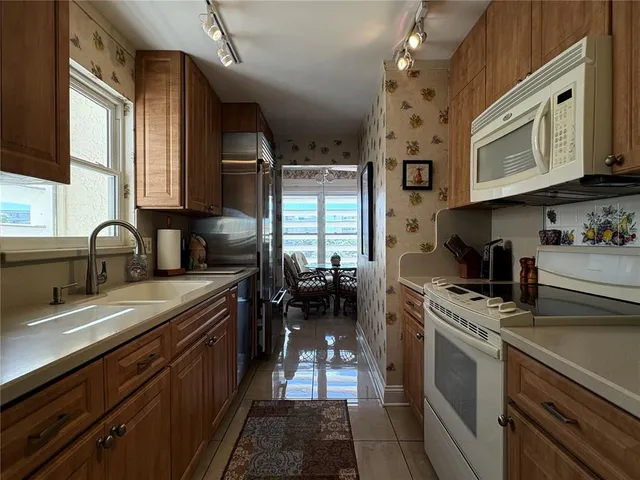 a kitchen with stainless steel appliances granite countertop a sink stove and cabinets