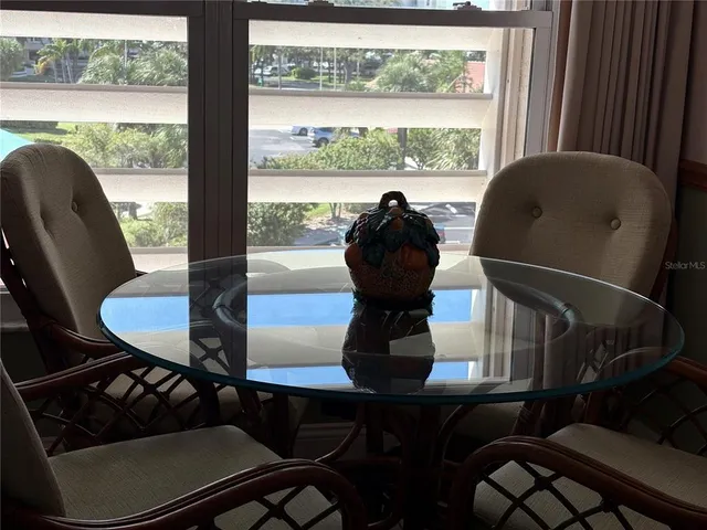 a view of a chairs and table in wooden floor