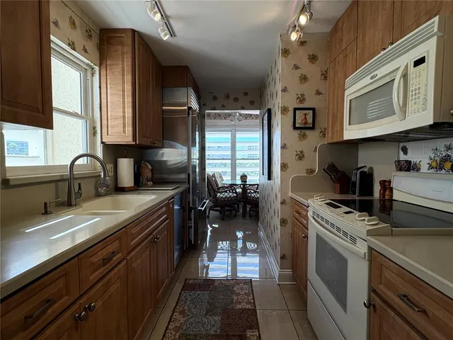 a kitchen with a sink cabinets and appliances