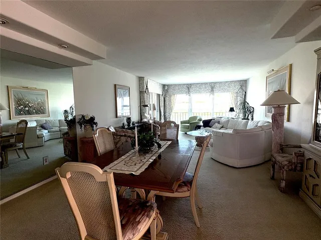 a living room with furniture potted plant a sink and a window