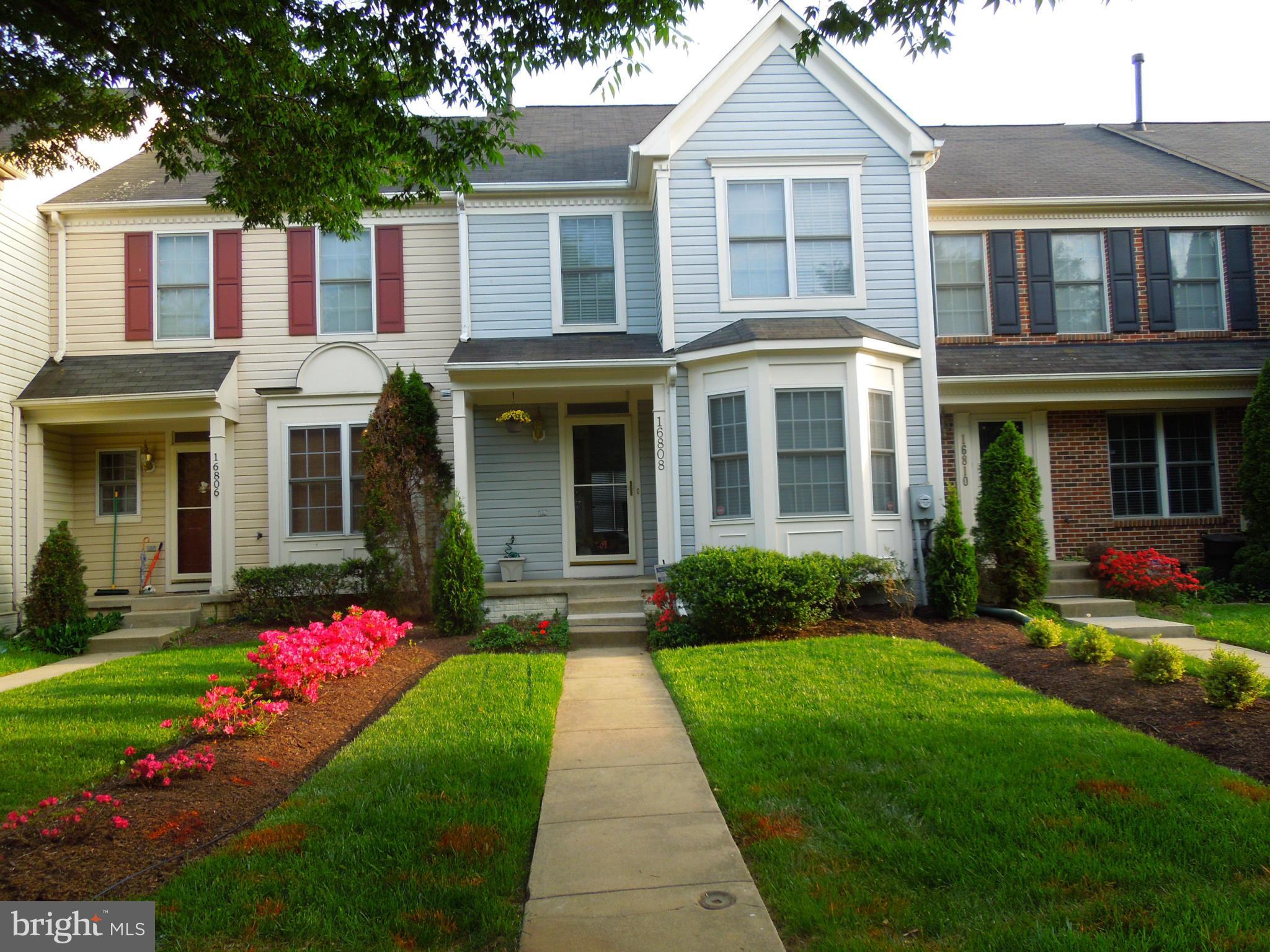 front view of a brick house with a yard