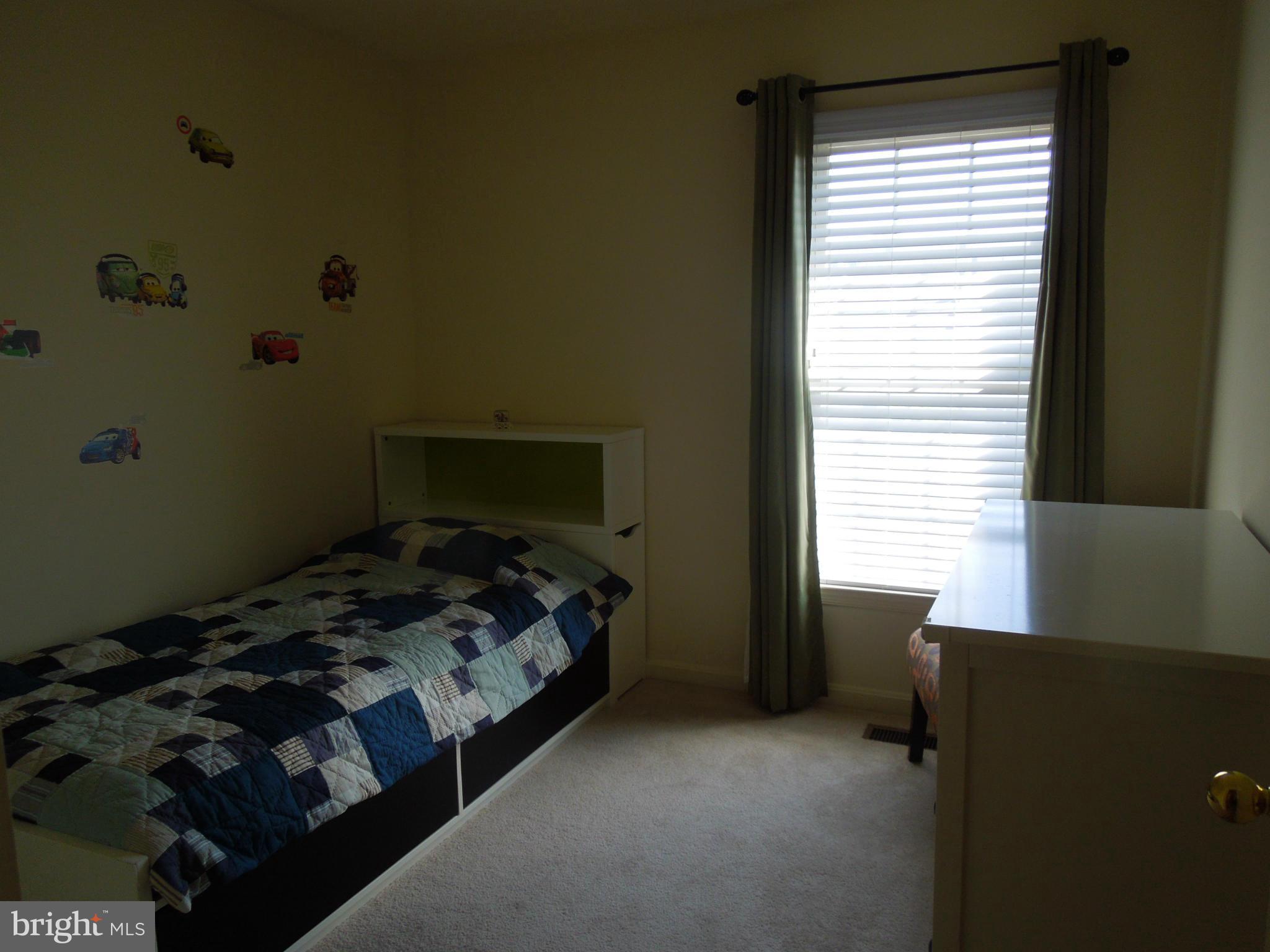 16808 Centerfield Way Olney, MD 20832 - Photo 13 of 22 a bed sitting in a bedroom next to a window