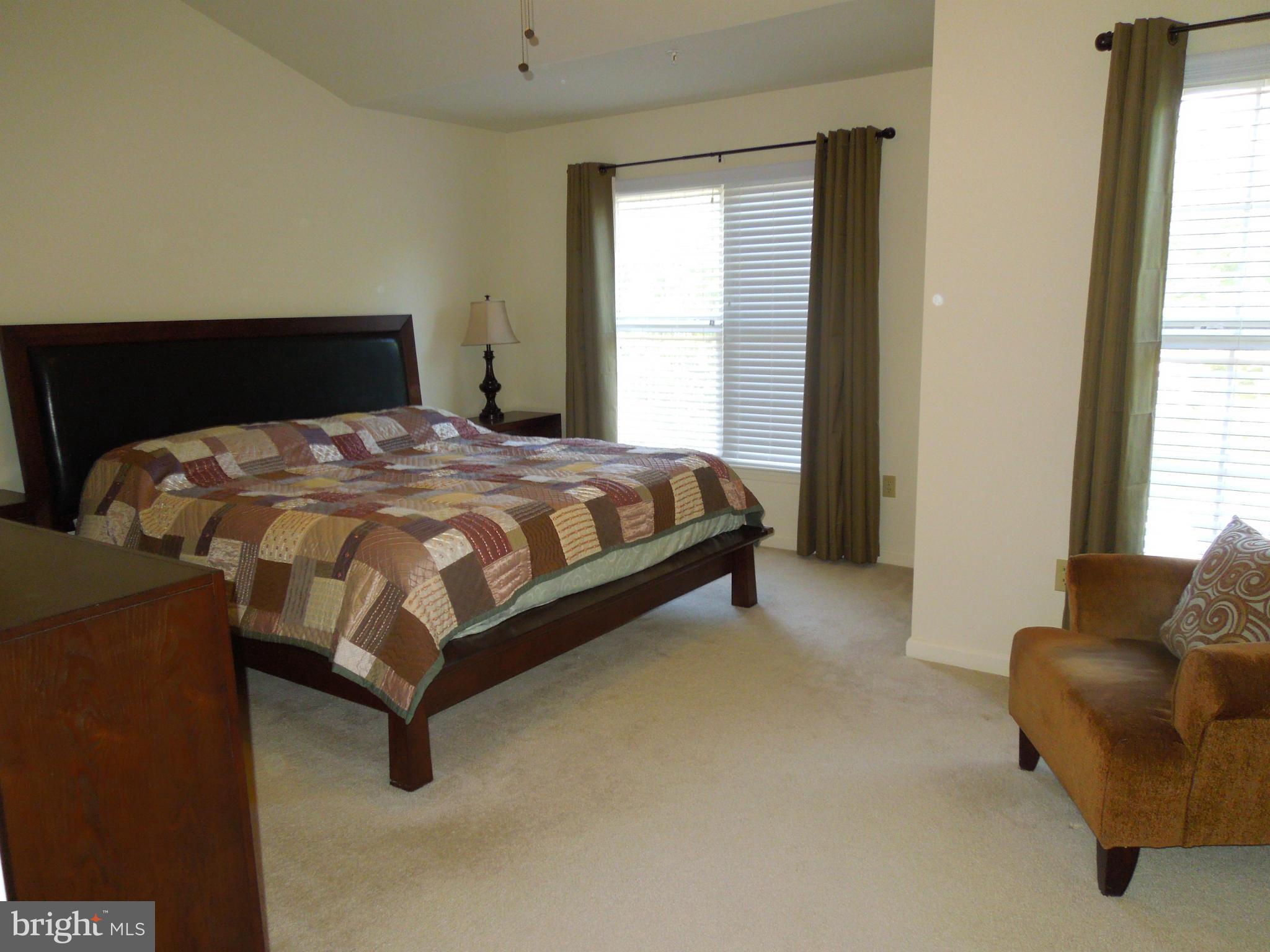 16808 Centerfield Way Olney, MD 20832 - Photo 14 of 22 a bedroom with a bed and a couch