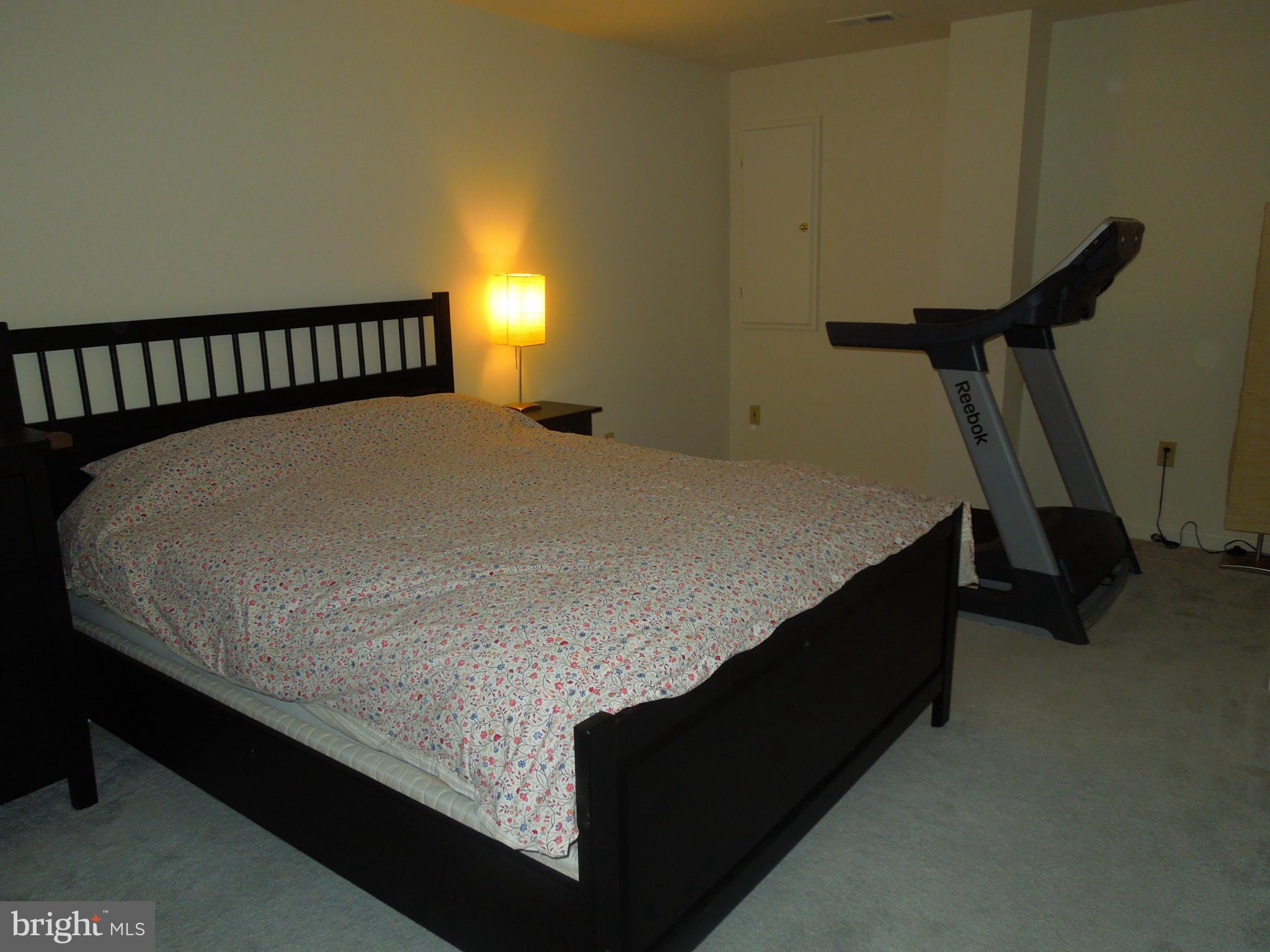 16808 Centerfield Way Olney, MD 20832 - Photo 18 of 22 a bed sitting in a bedroom next to a window