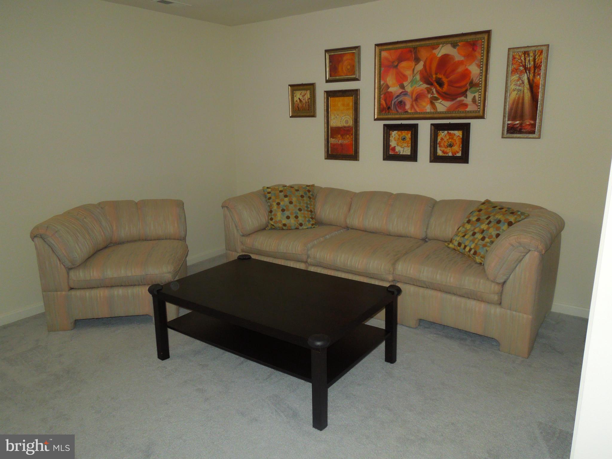 16808 Centerfield Way Olney, MD 20832 - Photo 19 of 22 a living room with furniture and a couch