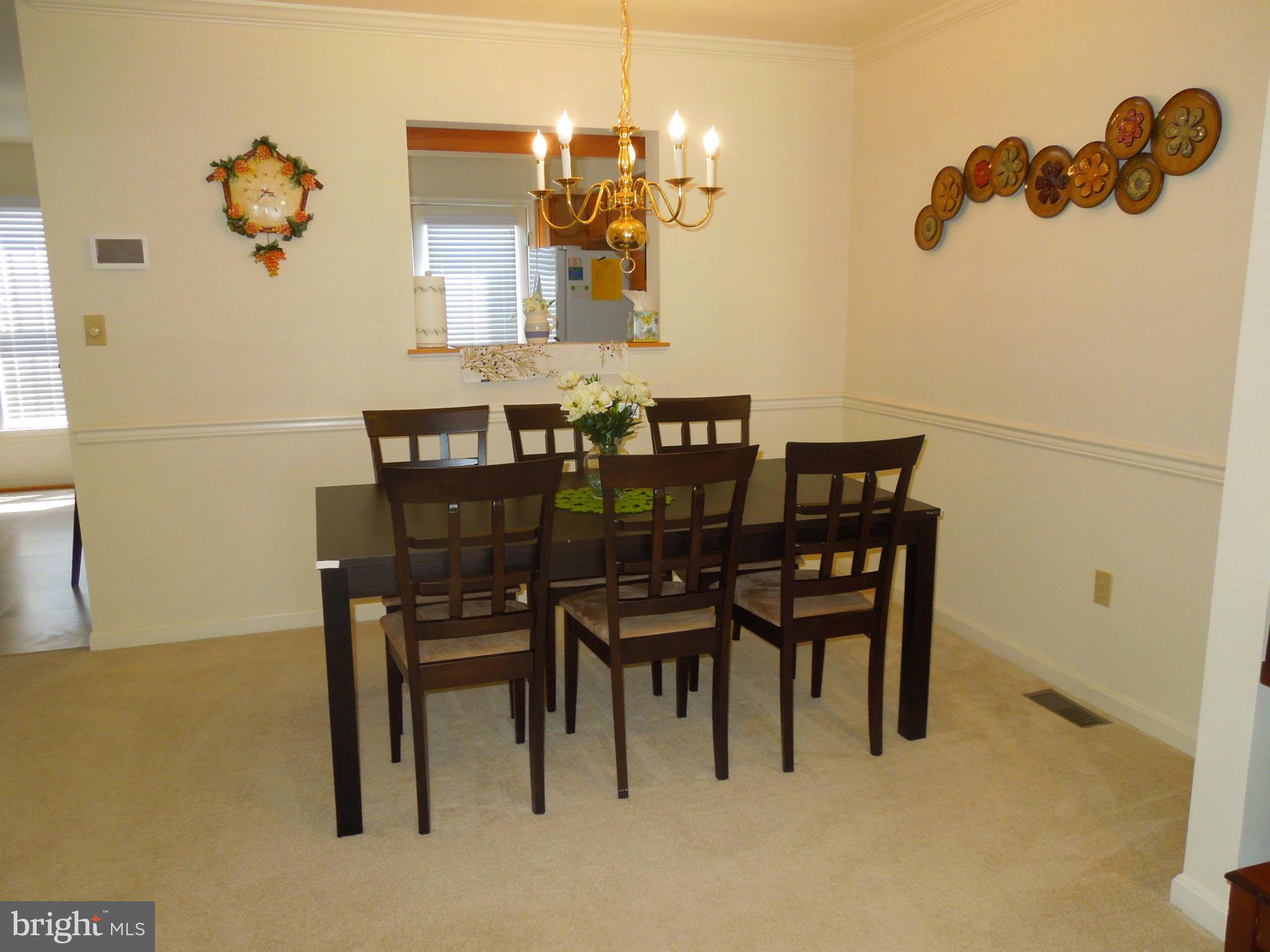 16808 Centerfield Way Olney, MD 20832 - Photo 5 of 22 a view of a dining room with furniture and chandelier