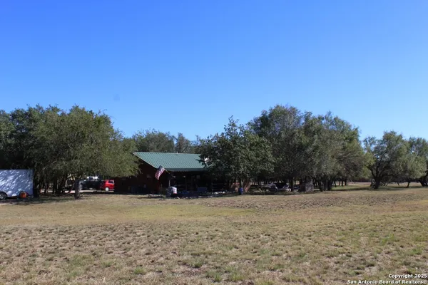 a view of empty field with trees in the background