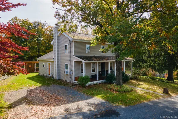 a front view of house with yard and green space