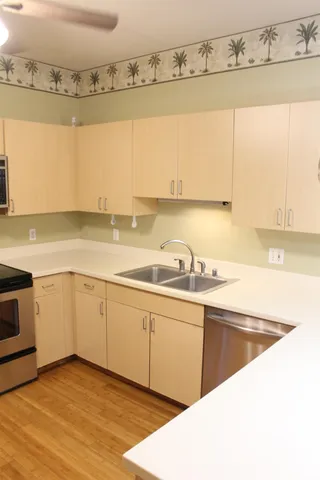 a view of a kitchen with a sink and cabinets