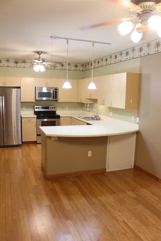 a kitchen with stainless steel appliances granite countertop a sink and a stove