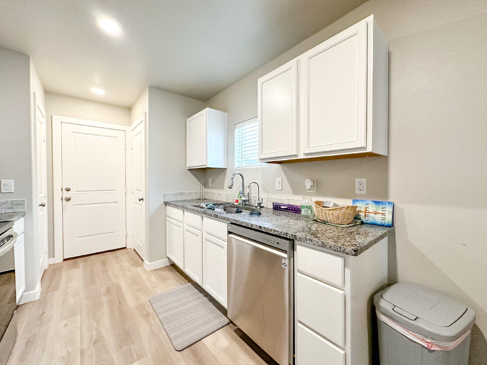 7413 35th Street Lubbock, TX 79407 - Photo 4 of 9 a kitchen with granite countertop a sink stove and cabinets