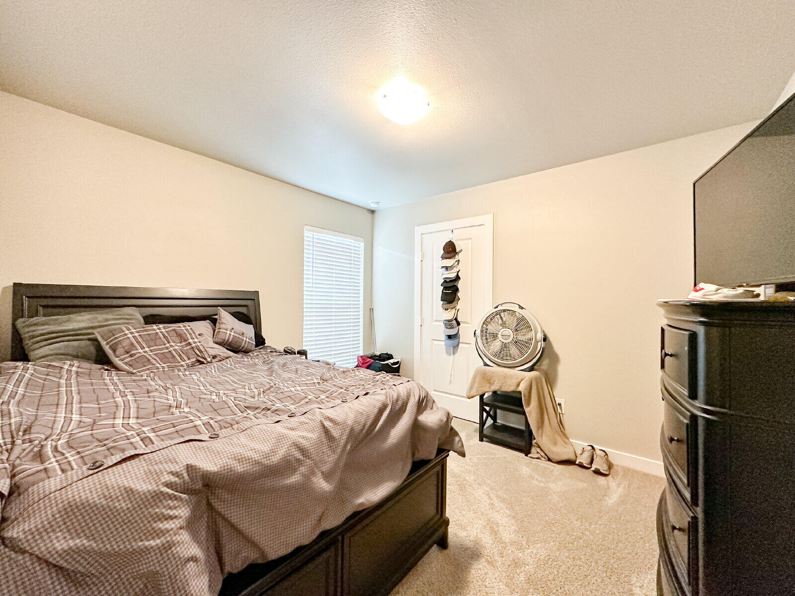 7413 35th Street Lubbock, TX 79407 - Photo 8 of 9 a bedroom with a bed and a chandelier