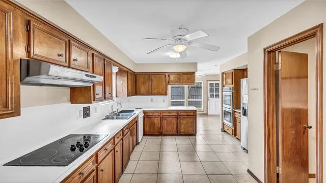 a kitchen with a stove a sink and a refrigerator