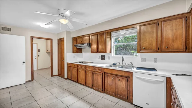 a kitchen with a sink stove and cabinets