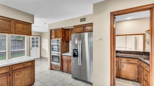 a kitchen with stainless steel appliances a refrigerator and a stove top oven