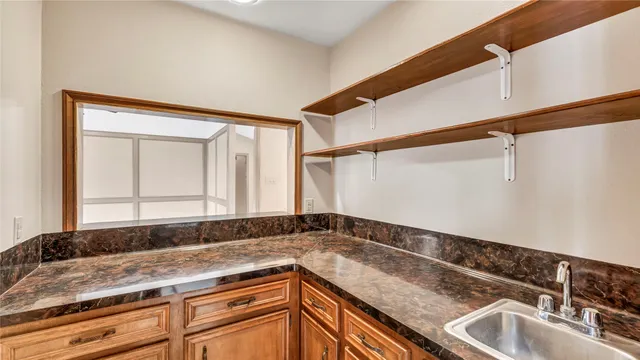 a view of a sink and dishwasher with wooden floor