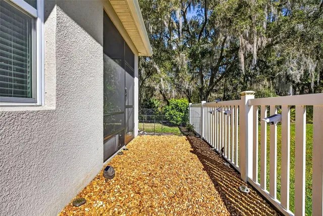 a view of a pathway of a house with wooden fence