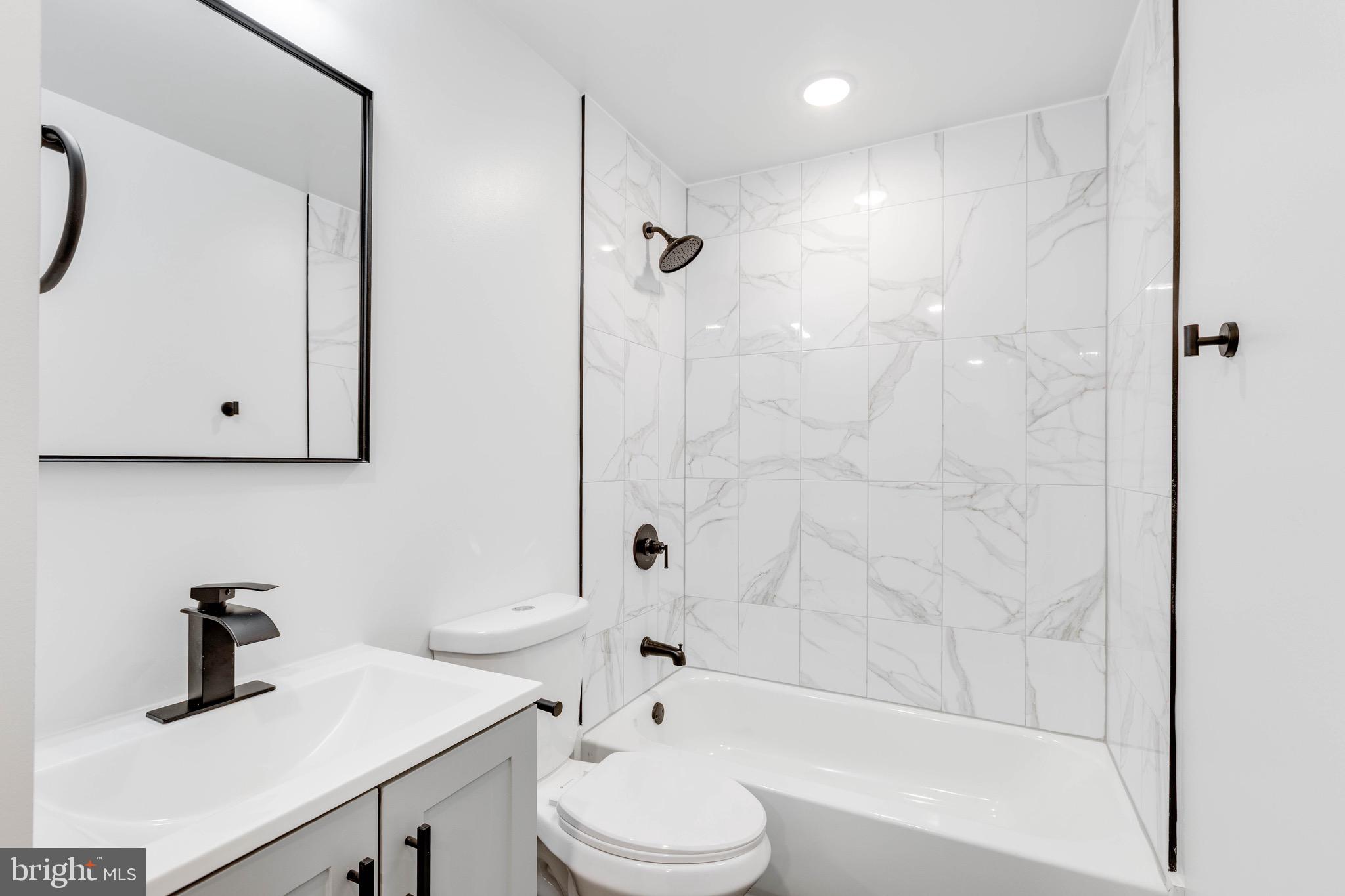 2339 North 16th Street, Unit 2 Philadelphia, PA 19132 - Photo 4 of 10 a bathroom with a sink toilet and shower