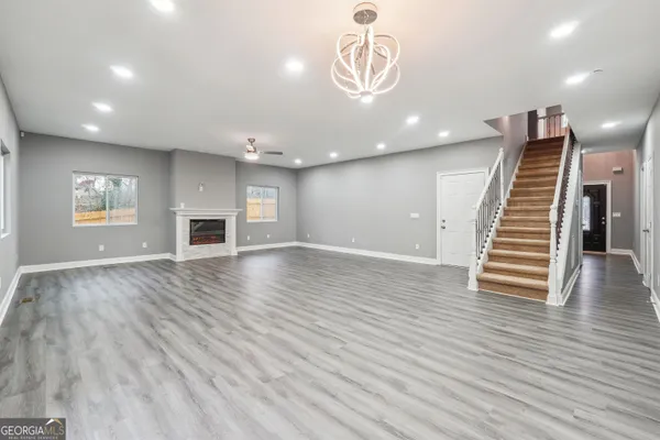 a view of empty room with wooden floor and fireplace