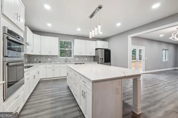a kitchen with a stove a sink and a refrigerator
