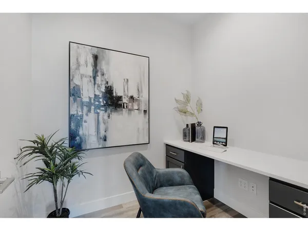 a living room with furniture a fireplace and potted plants