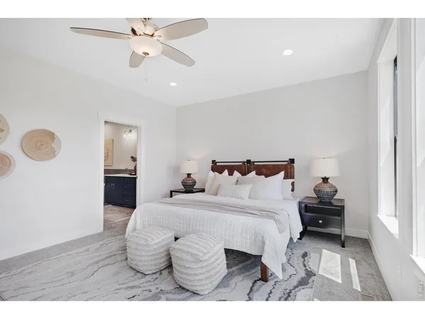 a spacious bedroom with a bed and window